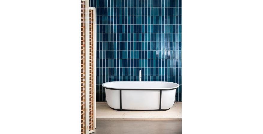 Designed by Patricia Urquiola for Agape, Cuna is a compact solid surface freestanding tub with a tubular steel frame. Available in multiple finish combinations, it has a 58-gallon capacity and measures approximately 65 inches by 20½ inches by 31 inches