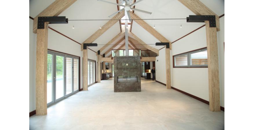 Exposed engineered wood beams inside barn house interior