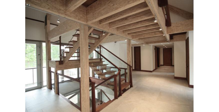 exposed engineered beams staircase barn house interior