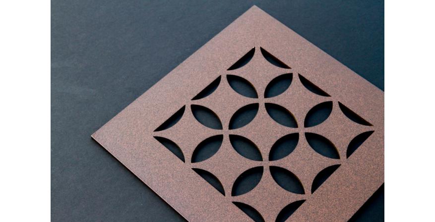 A brown grille from AJK Design Studio with a Moroccan pattern for AC registers.