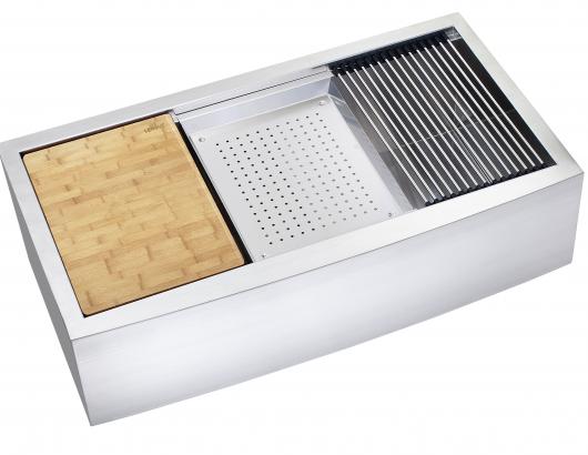 An apron-front sink from Lenova with a colander, grid drainer, and cutting board