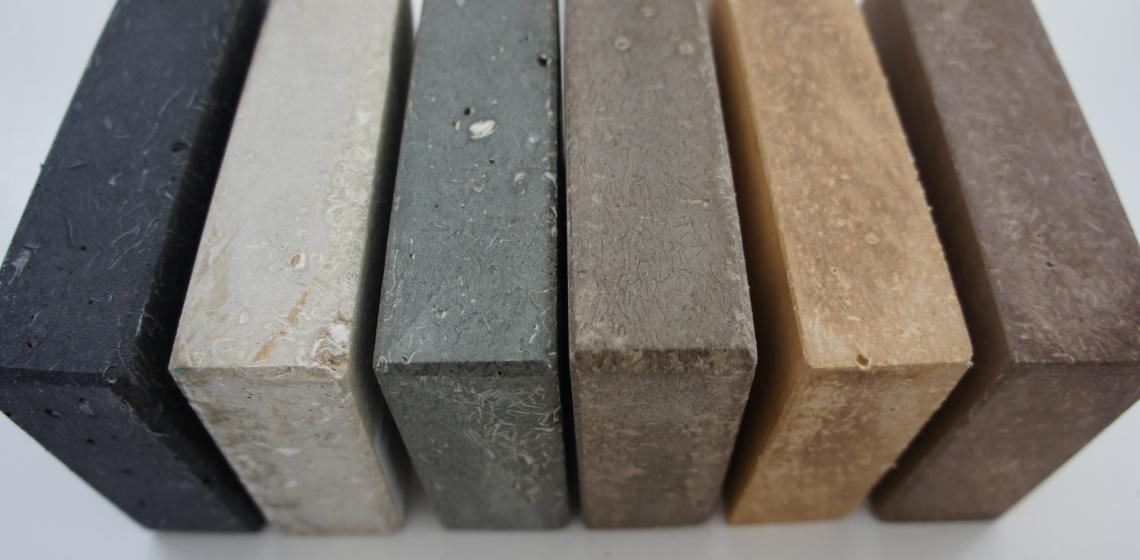 The manufacturer’s product is a fibrous-cement material comprised of recycled paper, recycled glass, and low-carbon cement. It is hand-cast into “slabs” as an alternative to natural or quarried stone and has the appearance of soapstone or limestone. 