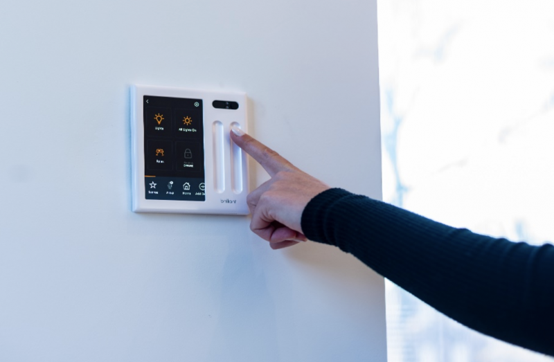Control panels feature a screen to access the Brilliant app, LED-compatible dimmer light switches, and a camera with optional privacy setting
