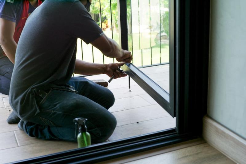 Person installing patio door hardware